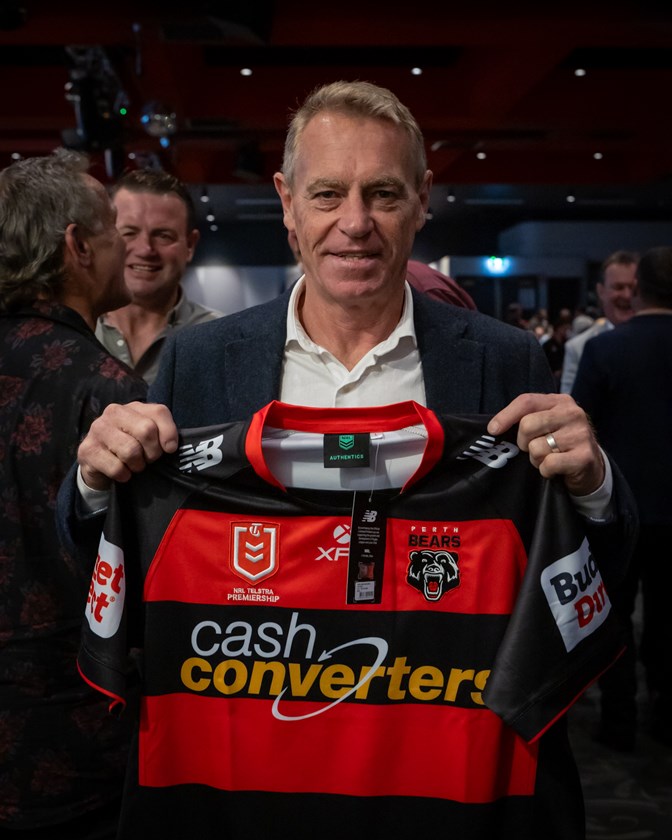 Greg Florimo holding the inaugural red-and-black Perth Bears jersey